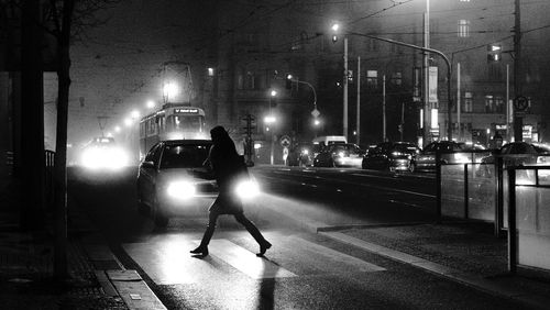 Cars on illuminated street at night