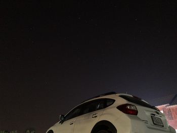 Low angle view of airplane against sky at night