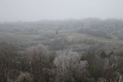 Scenic view of landscape against sky during foggy weather