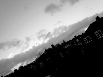 Low angle view of silhouette building against sky