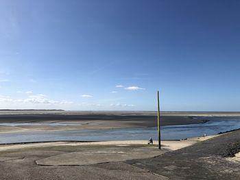 Scenic view of beach against blue sky