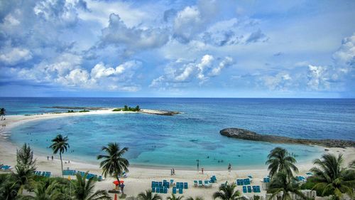 Scenic view of beach against cloudy sky