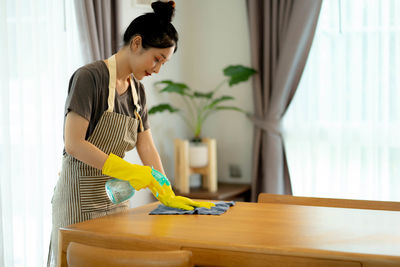 Side view of young man working at home