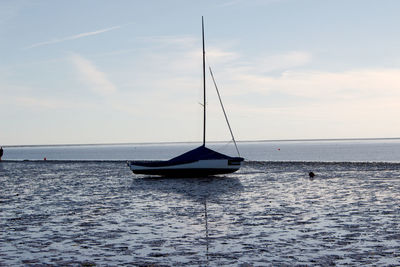 Sailboat on sea against sky