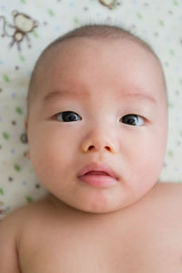 Portrait of baby boy with sad facial expression