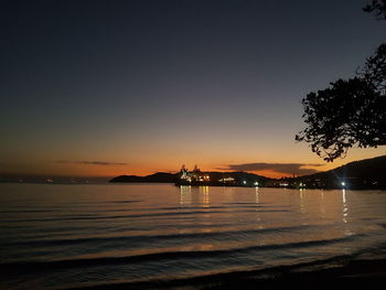 Scenic view of sea against clear sky during sunset