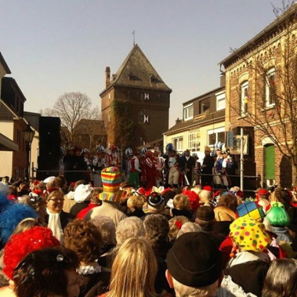 building exterior, architecture, large group of people, built structure, person, men, lifestyles, crowd, leisure activity, street, celebration, city, city life, mixed age range, tradition, outdoors, walking, cultures, traditional festival