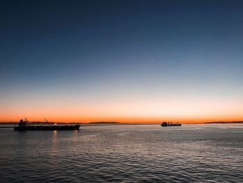 Scenic view of sea against clear sky during sunset