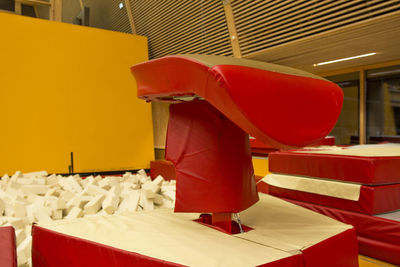 Close-up of empty chairs on table against wall