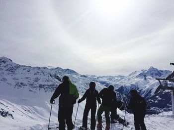 Tourists on snowcapped mountain