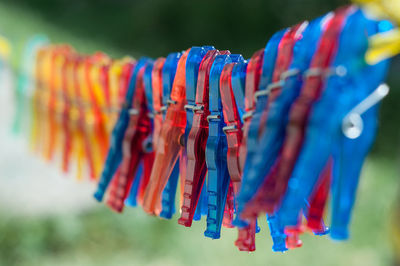 Close-up of multi colored ribbons hanging outdoors