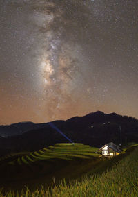 Scenic view of landscape against sky at night