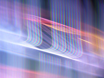 Close-up of light trails against blue background