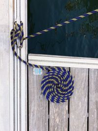 Close-up of ropes tied on metal railing