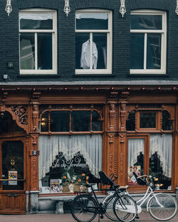 Bicycles on street by building in city