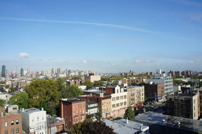 High angle view of cityscape against blue sky