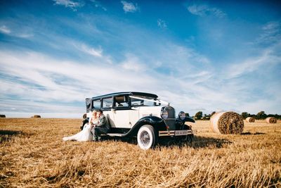 Hay bales on field against sky