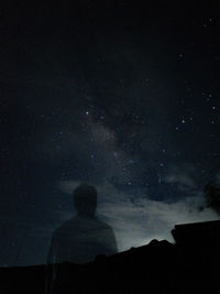 Low angle view of silhouette man against sky at night