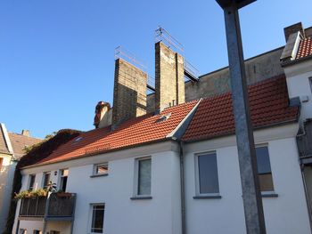 Low angle view of buildings against blue sky