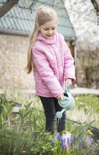 Cute girl holding pink flower