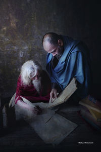 Portrait of man sitting on table