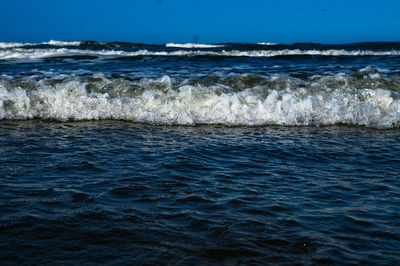 Scenic view of sea against blue sky