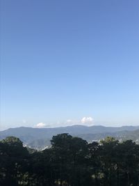 Scenic view of mountains against clear blue sky