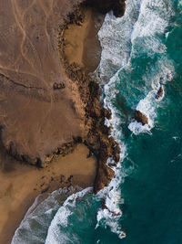 Aerial view of rock formation in sea