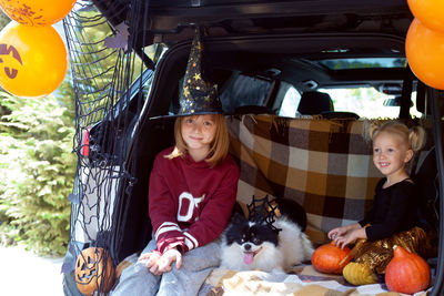 Portrait of smiling girl sitting in car