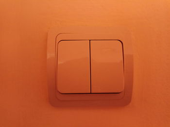 Directly above shot of electric lamp on orange wall