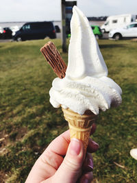 Close-up of hand holding ice cream cone