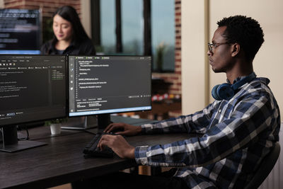 Side view of man working at office