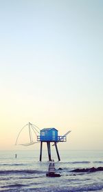 Lifeguard hut on beach against clear sky