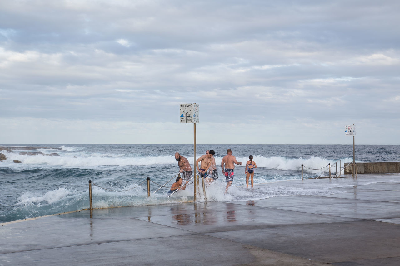 water, sky, sea, group of people, real people, cloud - sky, men, lifestyles, beach, horizon over water, nature, leisure activity, land, people, horizon, day, motion, scenics - nature, full length, outdoors