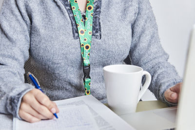 Midsection of man using laptop on table