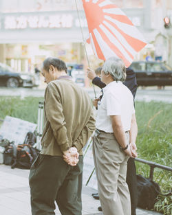 Rear view of friends walking outdoors