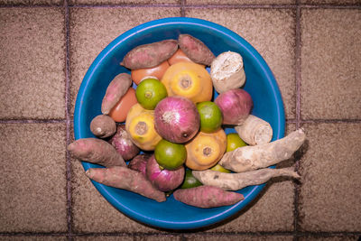 Directly above shot of vegetables and fruits in plastic container at home