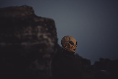Close-up of man wearing alien mask