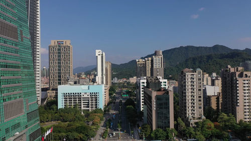 Buildings in city against clear sky