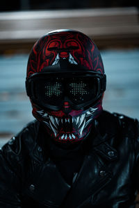 Portrait of a man in leather jacket and oni helmet