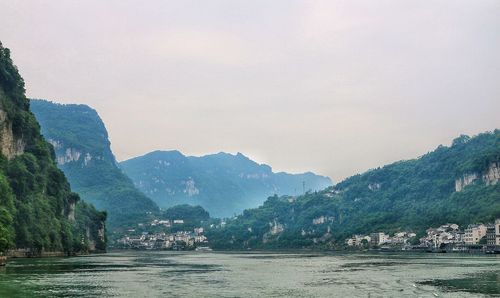 View of boats in sea against mountain range