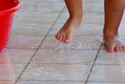 Low section of child on wet floor