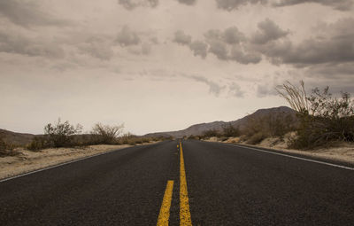 Road amidst landscape against sky