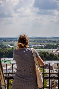Rear view of woman looking at cityscape