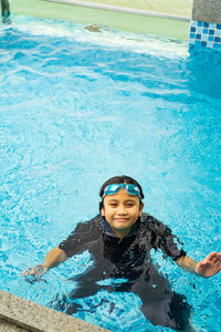 High angle portrait of girl swimming in pool