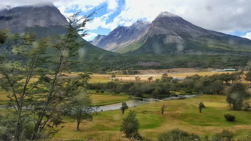 Scenic view of mountains against cloudy sky