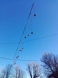 Low angle view of cables against clear blue sky