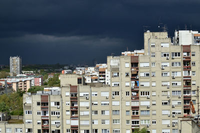 Stormy dark blue sky above a quarter of residential buildings
