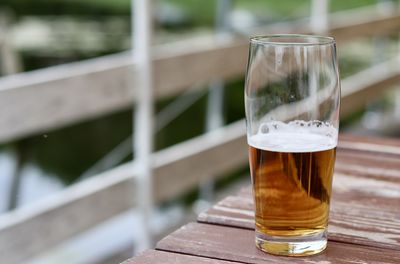 Close-up of beer glass on table
