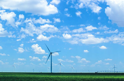 Windmill on field against sky